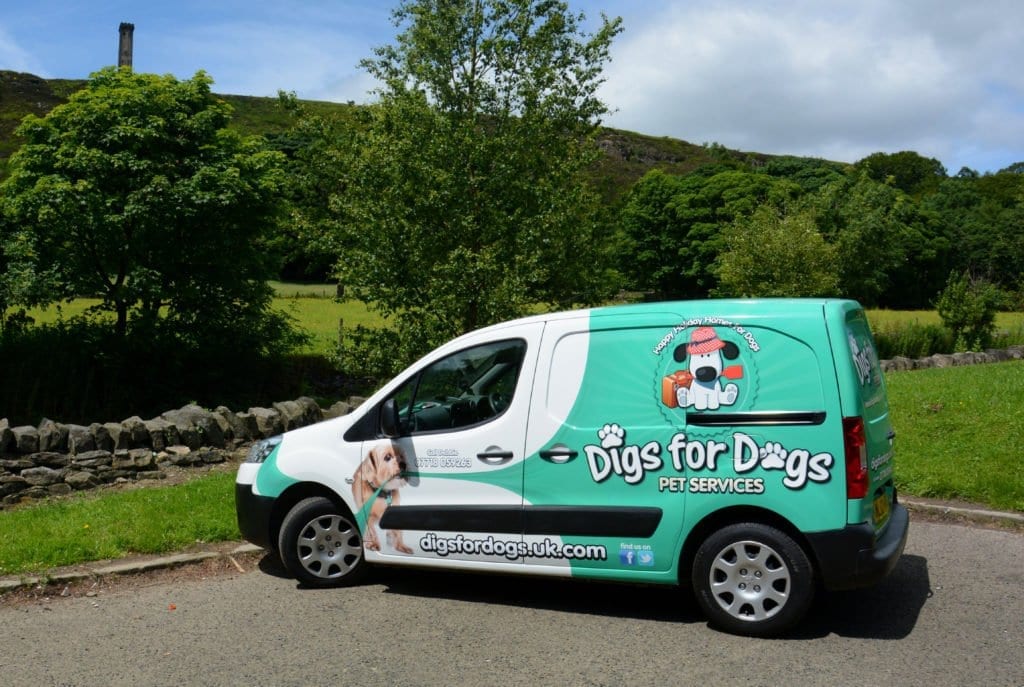 Branded Digs for Dogs pet taxi van parked in the countryside